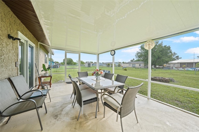 7580 Hanchey St, North Port, FL 34287 - sunroom / solarium with outdoor dining area, a fire pit, and healthy amount of natural light