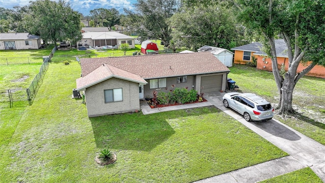 7580 Hanchey St, North Port, FL 34287 - ranch-style house with concrete driveway, a garage, a shingled roof, and stucco siding