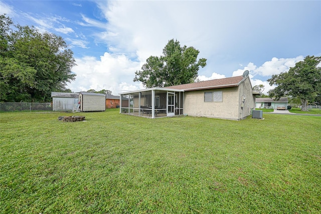 7580 Hanchey St, North Port, FL 34287 - rear view of property with a sunroom, a storage unit, and stucco siding