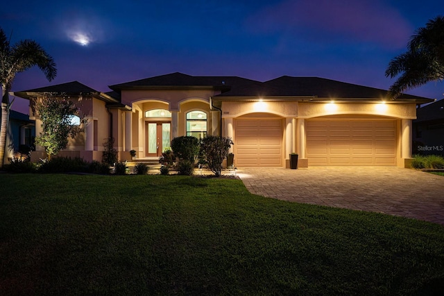 1131 Rotonda Cir, Rotonda West, FL 33947 - view of front of property with stucco siding, an attached garage, decorative driveway, and a front yard