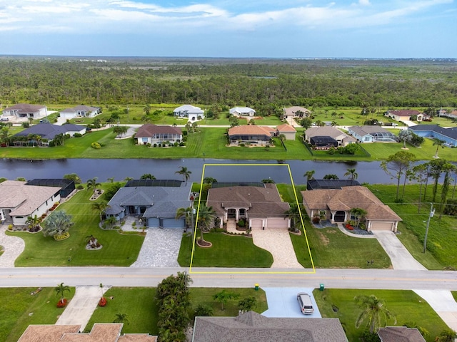 1131 Rotonda Cir, Rotonda West, FL 33947 - aerial view of residential area featuring property boundaries highlighted and a nearby body of water