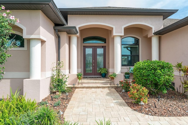 1131 Rotonda Cir, Rotonda West, FL 33947 - property entrance featuring french doors and stucco siding