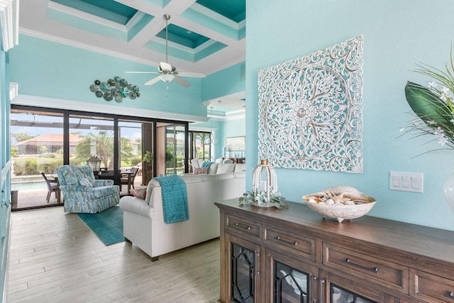 1131 Rotonda Cir, Rotonda West, FL 33947 - living area featuring a high ceiling, coffered ceiling, beam ceiling, a ceiling fan, and ornamental molding