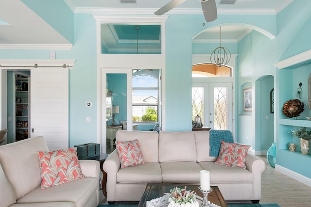 1131 Rotonda Cir, Rotonda West, FL 33947 - living room with arched walkways, ornamental molding, a ceiling fan, a chandelier, and french doors