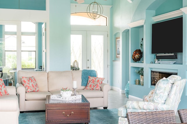 1131 Rotonda Cir, Rotonda West, FL 33947 - living room featuring plenty of natural light, a chandelier, wood finished floors, and built in features