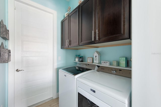 1131 Rotonda Cir, Rotonda West, FL 33947 - laundry room featuring washer and dryer, cabinet space, and light wood-style flooring
