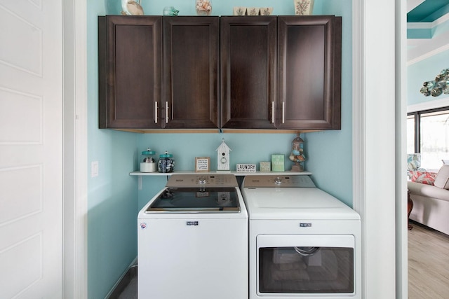 1131 Rotonda Cir, Rotonda West, FL 33947 - laundry room featuring cabinet space, independent washer and dryer, wood finished floors, and ornamental molding