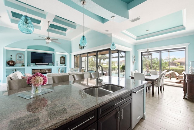 1131 Rotonda Cir, Rotonda West, FL 33947 - kitchen featuring stainless steel dishwasher, coffered ceiling, dark stone counters, crown molding, and open floor plan