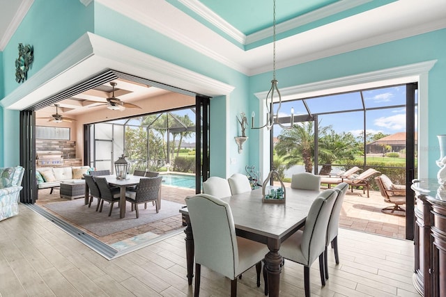 1131 Rotonda Cir, Rotonda West, FL 33947 - dining room featuring a ceiling fan, a sunroom, plenty of natural light, ornamental molding, and light wood finished floors