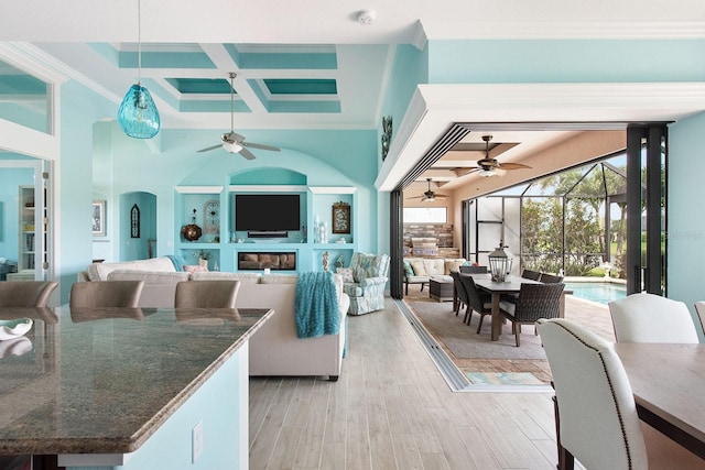 1131 Rotonda Cir, Rotonda West, FL 33947 - living room featuring a ceiling fan, coffered ceiling, crown molding, light wood-style flooring, and beamed ceiling