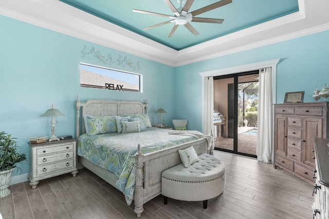 1131 Rotonda Cir, Rotonda West, FL 33947 - bedroom with a tray ceiling, multiple windows, access to exterior, wood finished floors, and ornamental molding