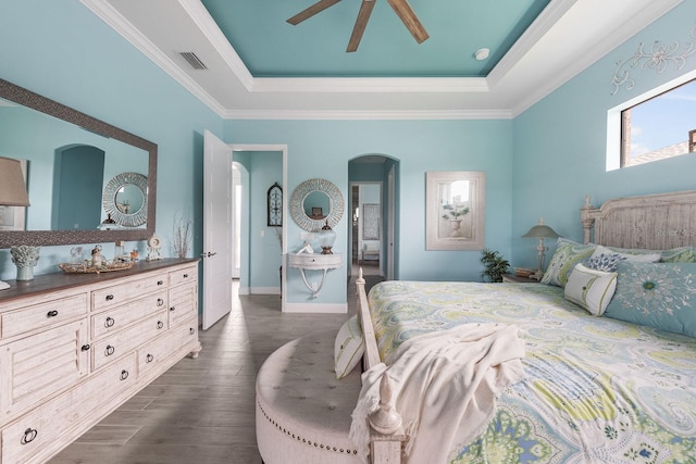 1131 Rotonda Cir, Rotonda West, FL 33947 - bedroom featuring arched walkways, a tray ceiling, dark wood-type flooring, crown molding, and ceiling fan