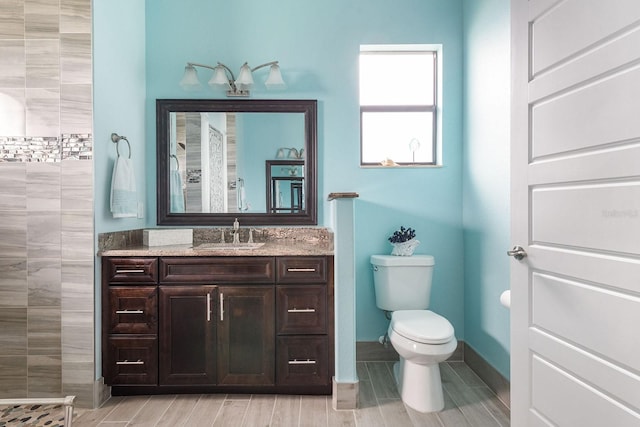 1131 Rotonda Cir, Rotonda West, FL 33947 - bathroom with vanity, tiled shower, and wood finish floors
