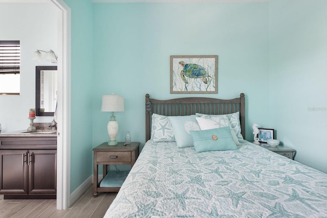 1131 Rotonda Cir, Rotonda West, FL 33947 - bedroom featuring light wood-style floors and ensuite bath