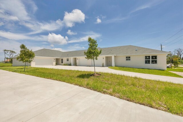 234 Boundary Blvd Unit 3, Rotonda West, FL 33947 - ranch-style home with an attached garage, concrete driveway, a front yard, and stucco siding