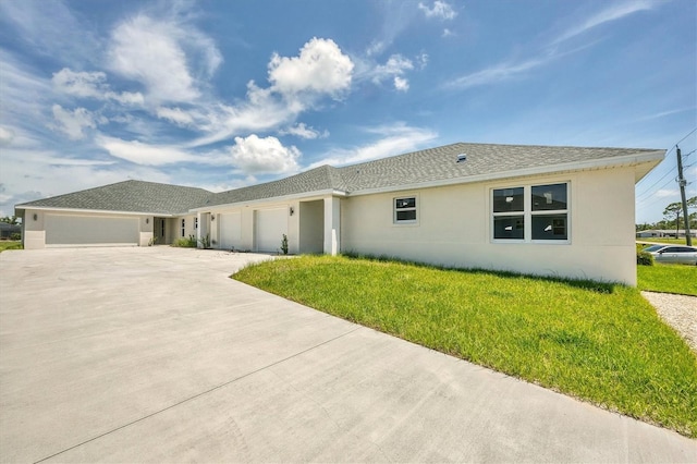 234 Boundary Blvd Unit 3, Rotonda West, FL 33947 - view of front of house featuring stucco siding, a garage, driveway, and a front yard