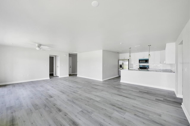234 Boundary Blvd Unit 3, Rotonda West, FL 33947 - unfurnished living room with a ceiling fan and light wood finished floors