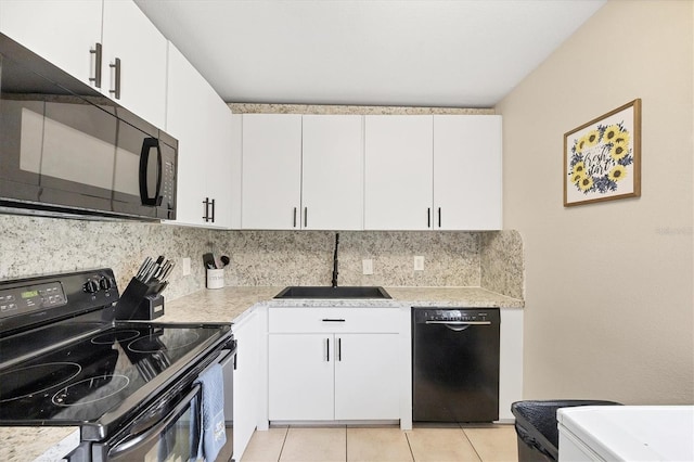 7590 Lyncrest St, North Port, FL 34287 - kitchen featuring black appliances, decorative backsplash, white cabinetry, and light tile patterned floors