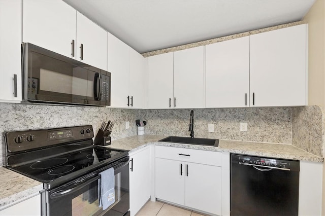 7590 Lyncrest St, North Port, FL 34287 - kitchen with black appliances, light countertops, white cabinets, and decorative backsplash