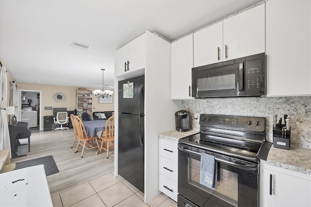 7590 Lyncrest St, North Port, FL 34287 - kitchen featuring black appliances, a chandelier, light countertops, white cabinetry, and decorative backsplash