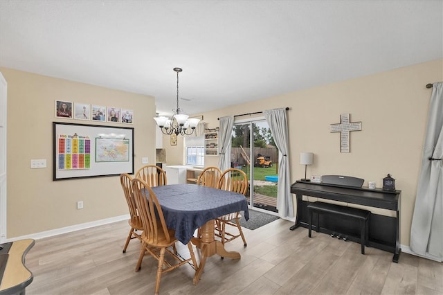7590 Lyncrest St, North Port, FL 34287 - dining room featuring a chandelier and wood finished floors
