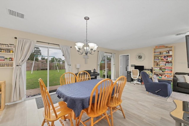 7590 Lyncrest St, North Port, FL 34287 - dining space featuring plenty of natural light, a chandelier, and light wood-style flooring