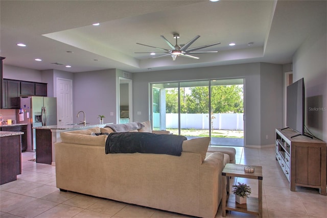 22156 Deborah Ave, Port Charlotte, FL 33954 - living room featuring a tray ceiling, a ceiling fan, light tile patterned floors, and recessed lighting