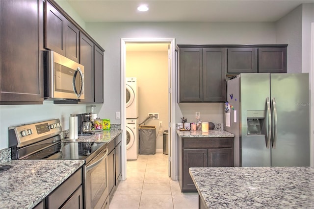 22156 Deborah Ave, Port Charlotte, FL 33954 - kitchen with stainless steel appliances, stacked washer and clothes dryer, recessed lighting, and dark brown cabinetry