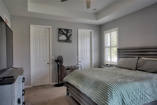 22156 Deborah Ave, Port Charlotte, FL 33954 - bedroom with a tray ceiling, light carpet, and ceiling fan