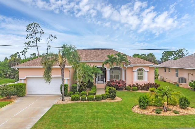 4 Pine Valley Pl, Rotonda West, FL 33947 - mediterranean / spanish-style house with an attached garage, concrete driveway, stucco siding, and a front yard