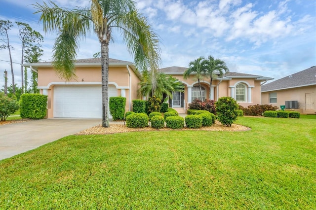 4 Pine Valley Pl, Rotonda West, FL 33947 - view of front facade with driveway, stucco siding, an attached garage, and a front yard