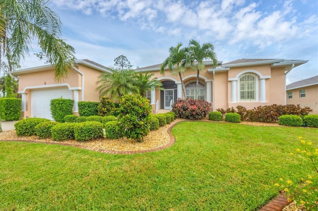 4 Pine Valley Pl, Rotonda West, FL 33947 - view of front facade with an attached garage, a front yard, and stucco siding