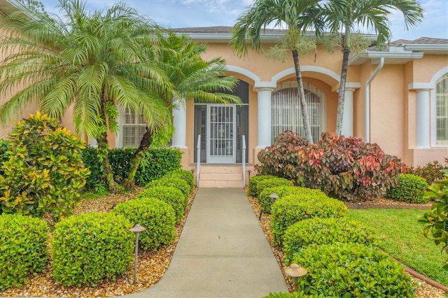 4 Pine Valley Pl, Rotonda West, FL 33947 - doorway to property with stucco siding