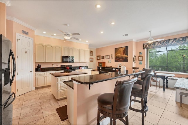 4 Pine Valley Pl, Rotonda West, FL 33947 - kitchen with black appliances, a kitchen island, cream cabinets, ceiling fan, and recessed lighting