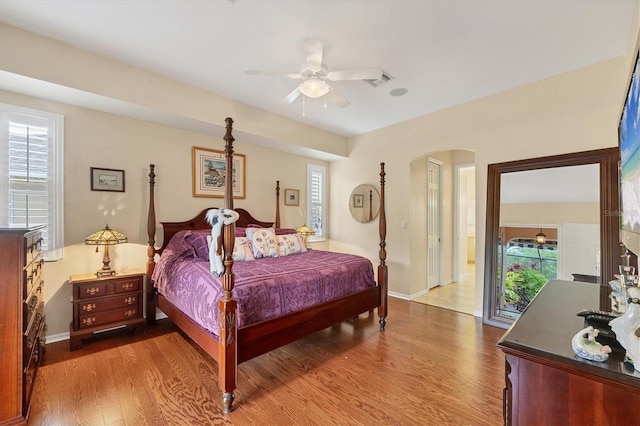 4 Pine Valley Pl, Rotonda West, FL 33947 - bedroom with dark wood finished floors, arched walkways, and multiple windows