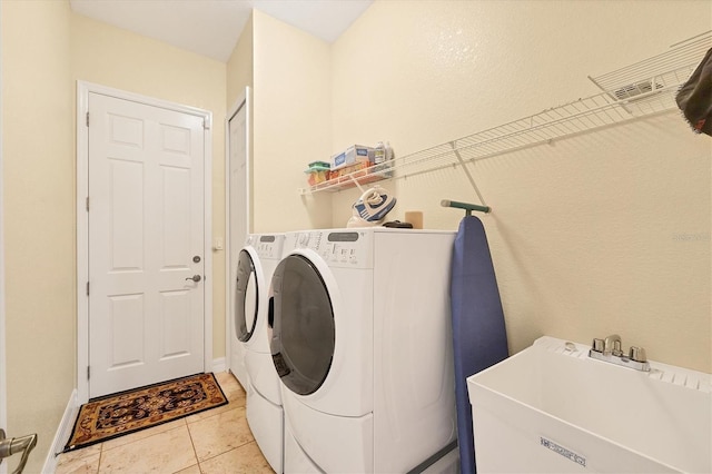 4 Pine Valley Pl, Rotonda West, FL 33947 - laundry room featuring washing machine and clothes dryer and light tile patterned floors