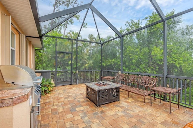 4 Pine Valley Pl, Rotonda West, FL 33947 - view of patio / terrace with an outdoor fire pit, glass enclosure, and exterior kitchen