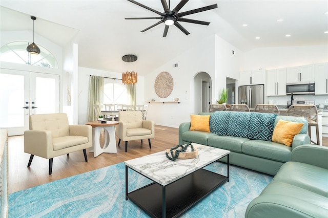 172 Mariner Ln, Rotonda West, FL 33947 - living room with arched walkways, ceiling fan, light wood finished floors, high vaulted ceiling, and french doors