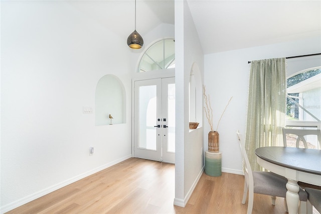 172 Mariner Ln, Rotonda West, FL 33947 - foyer entrance featuring light wood finished floors, healthy amount of natural light, vaulted ceiling, and french doors