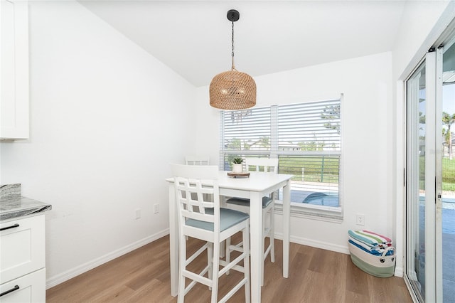 172 Mariner Ln, Rotonda West, FL 33947 - dining room with light wood finished floors and vaulted ceiling