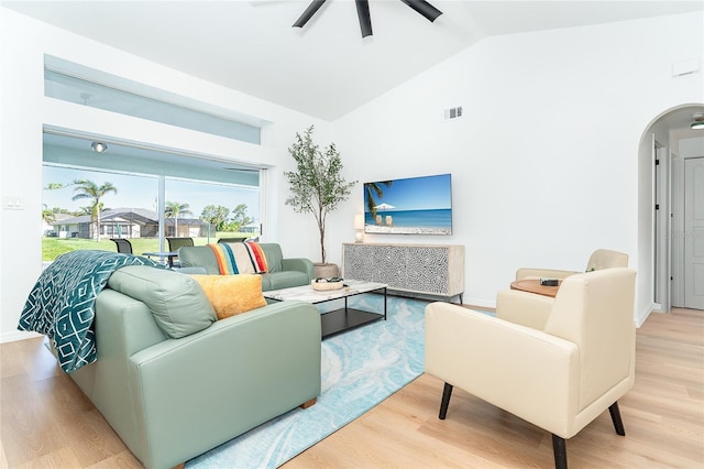 172 Mariner Ln, Rotonda West, FL 33947 - living room with arched walkways, wood finished floors, a ceiling fan, and high vaulted ceiling