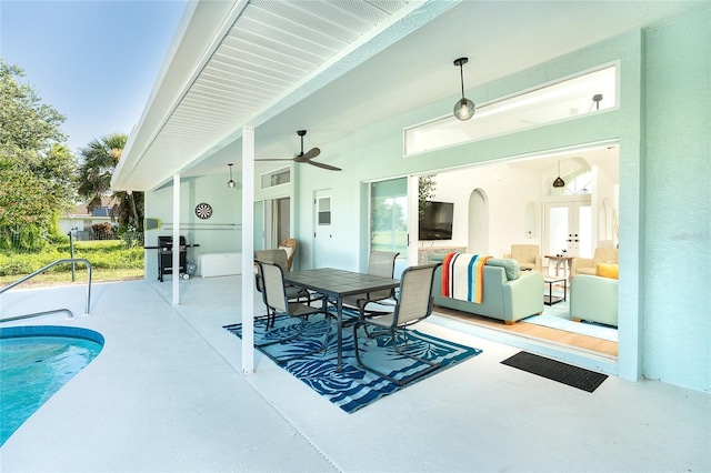 172 Mariner Ln, Rotonda West, FL 33947 - view of patio / terrace featuring ceiling fan, area for grilling, outdoor dining space, an outdoor pool, and french doors