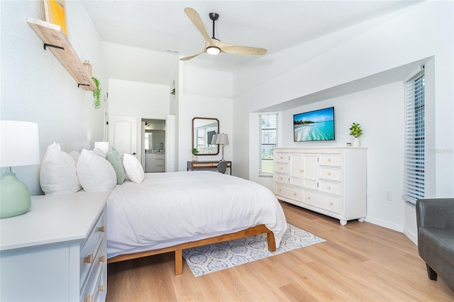 172 Mariner Ln, Rotonda West, FL 33947 - bedroom with light wood-style floors, vaulted ceiling, connected bathroom, and a ceiling fan