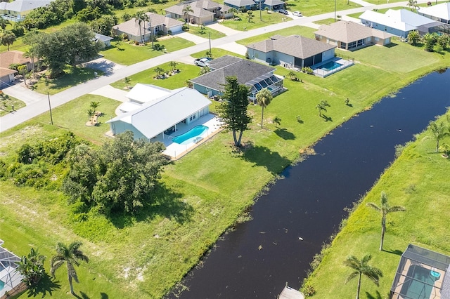 172 Mariner Ln, Rotonda West, FL 33947 - aerial perspective of suburban area featuring a large body of water and a pool area