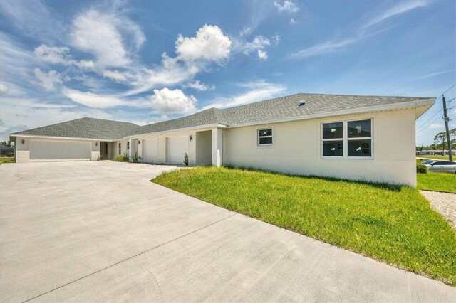 236 Boundary Blvd, Rotonda West, FL 33947 - view of front of house featuring stucco siding, a garage, driveway, and a front yard