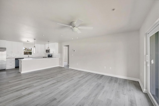 236 Boundary Blvd, Rotonda West, FL 33947 - unfurnished living room featuring light wood-type flooring and a ceiling fan