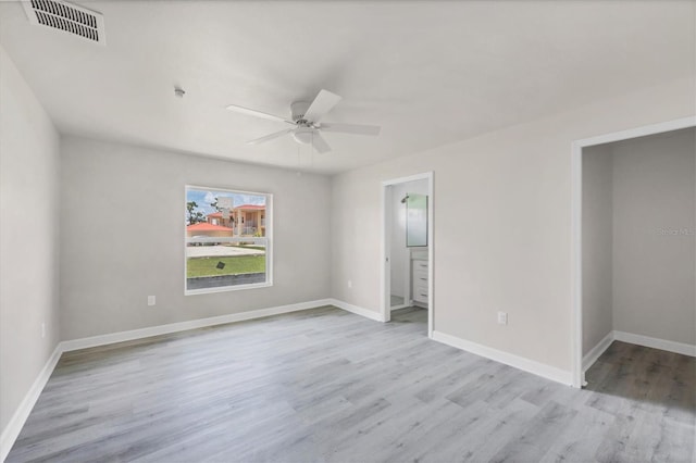 236 Boundary Blvd, Rotonda West, FL 33947 - unfurnished bedroom with wood finished floors, connected bathroom, and ceiling fan