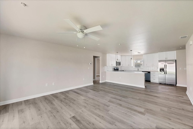 236 Boundary Blvd, Rotonda West, FL 33947 - unfurnished living room with light wood-type flooring and a ceiling fan
