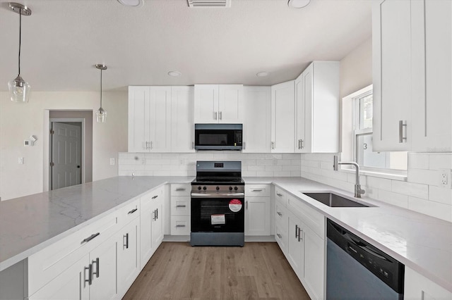 236 Boundary Blvd, Rotonda West, FL 33947 - kitchen featuring stainless steel appliances, light stone counters, white cabinets, and recessed lighting