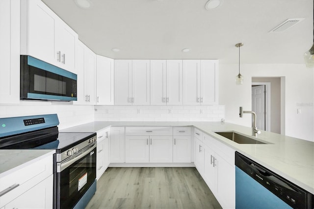 236 Boundary Blvd, Rotonda West, FL 33947 - kitchen featuring electric range, dishwasher, backsplash, light stone countertops, and white cabinets